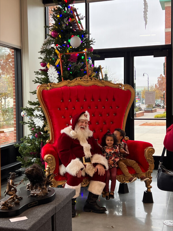 two children visiting Santa
