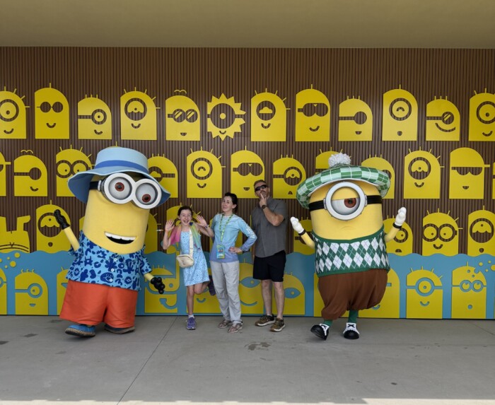 amanda murphy and her family posing with two large minions