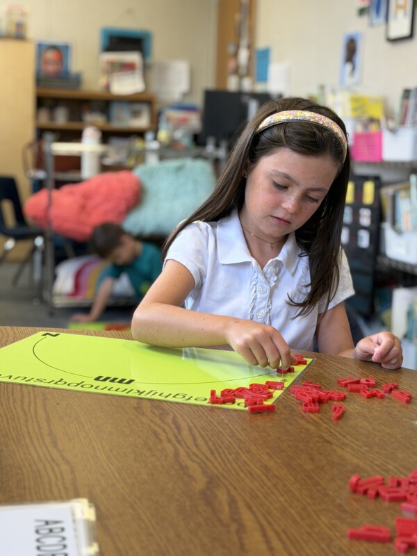a girl doing a rainbow literacy activity